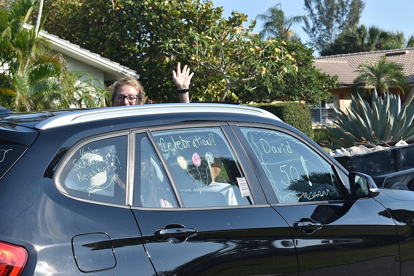 Jean Decicco waves from her car.