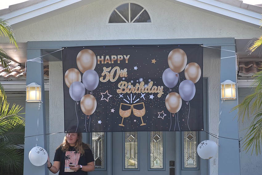 The family hung a sign over the front door to bring the party outside.