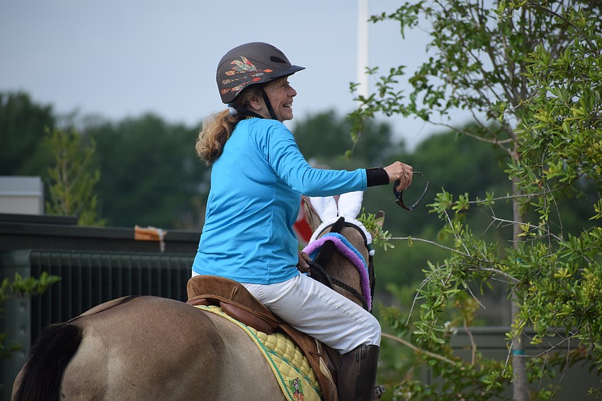 Sylvia McNichol leads the procession around the Grand Living building.