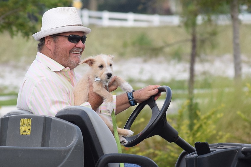 The Sarasota Polo Ranch's Tommy Klauber and his dog, Wrangler, chose a utility vehicle instead of a horse for the parade.