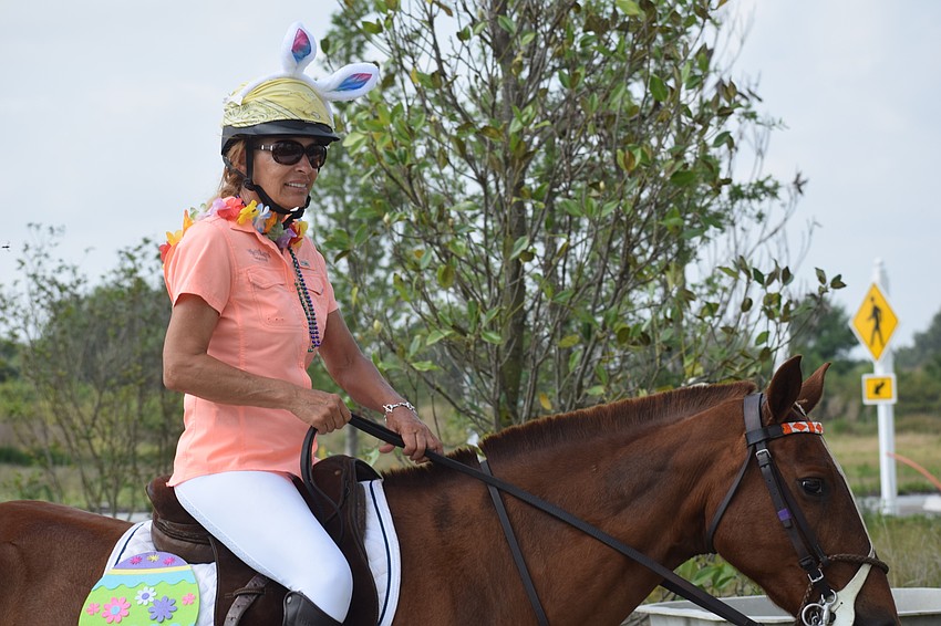 Polo player Tammy Wyman makes her way around Grand Living during an Easter parade put together to entertain the residents.