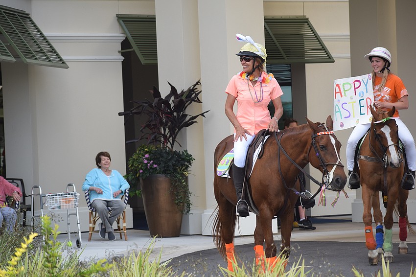 Tammy Wyman and Pippa Campbell greet residents of Grand Living by the front entrance.