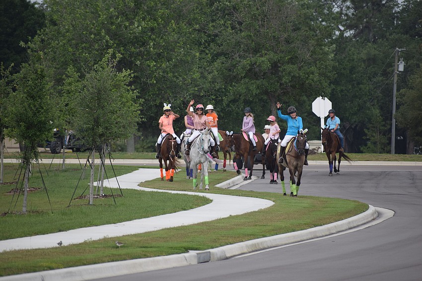 The riders cross Lorraine Boulevard and head to Grand Living at Lakewood Ranch.