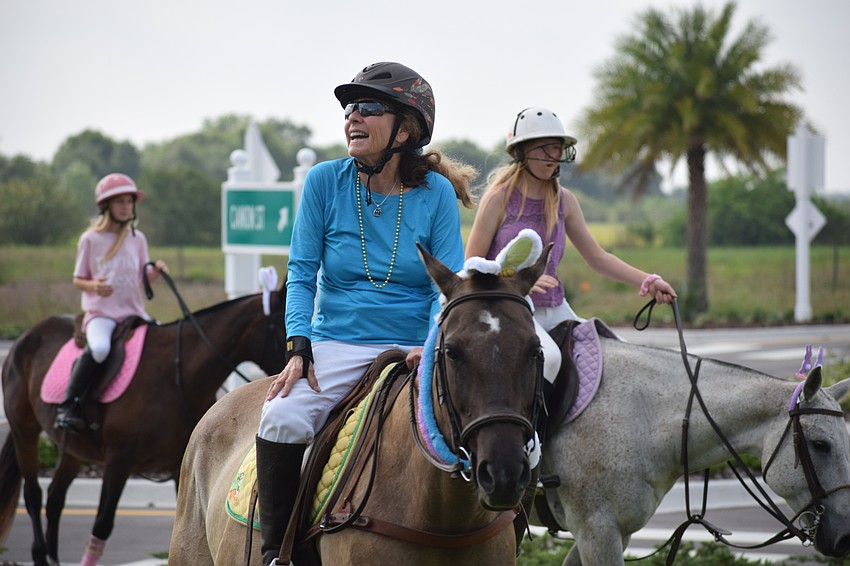 Sylvia McNichol exchanges Easter greetings with residents of Grand Living.