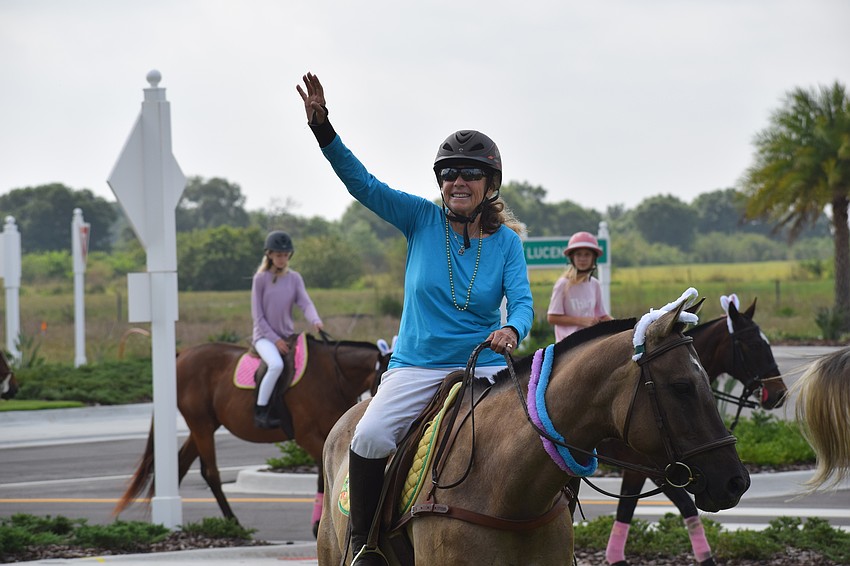 Sylvia McNichol leads the procession of riders into Grand Living at Lakewood Ranch.