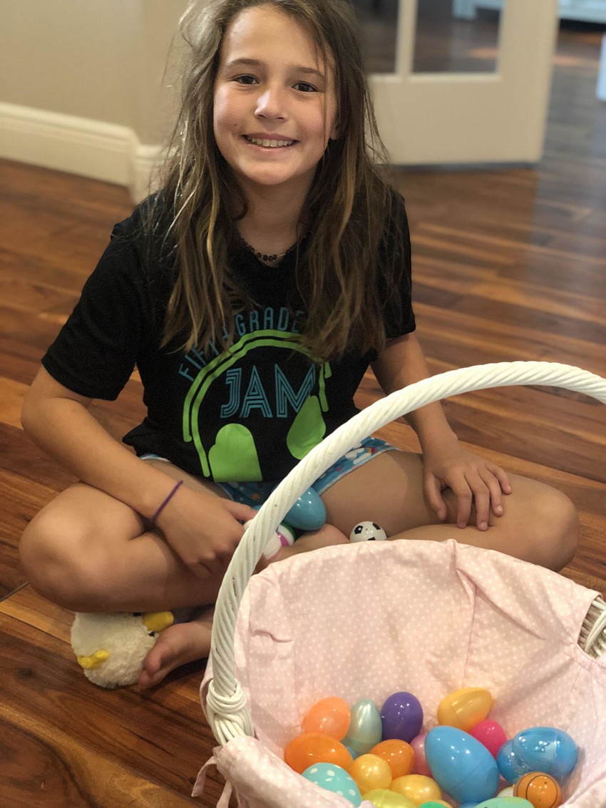 Abigail Johnson, 10, of River Club begins to go through her Easter eggs to see what other surprises await her.