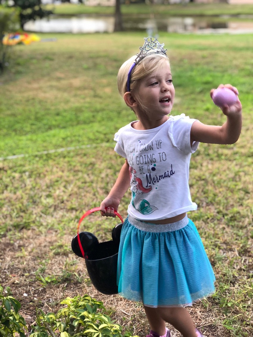 Stella Niecestro, 4, of Lakewood Ranch finds a prized Easter egg in her backyard.
