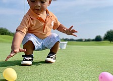 One-year-old Niko Rossi Sharma finds Easter eggs on the No. 3 hole of the King’s Dune Course in Lakewood Ranch. He is the grandson of Gloria Bracciano and Greg Van Natter.