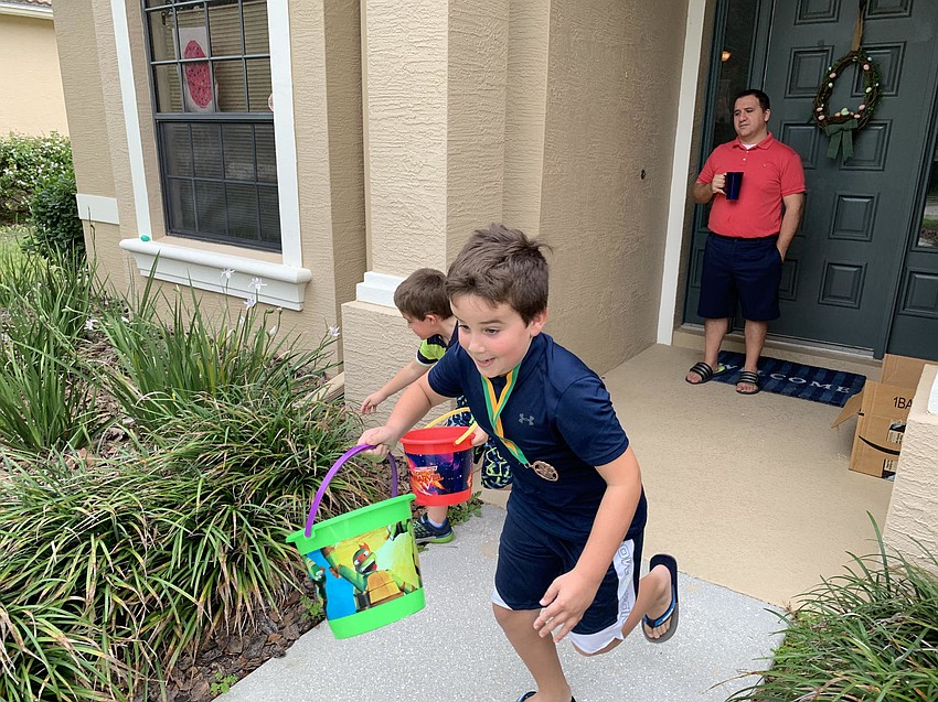 Salvatore DePaolis watches as his sons, 6-year-old Lucca and 8-year-old Giona race for eggs at their Greenbrook home.