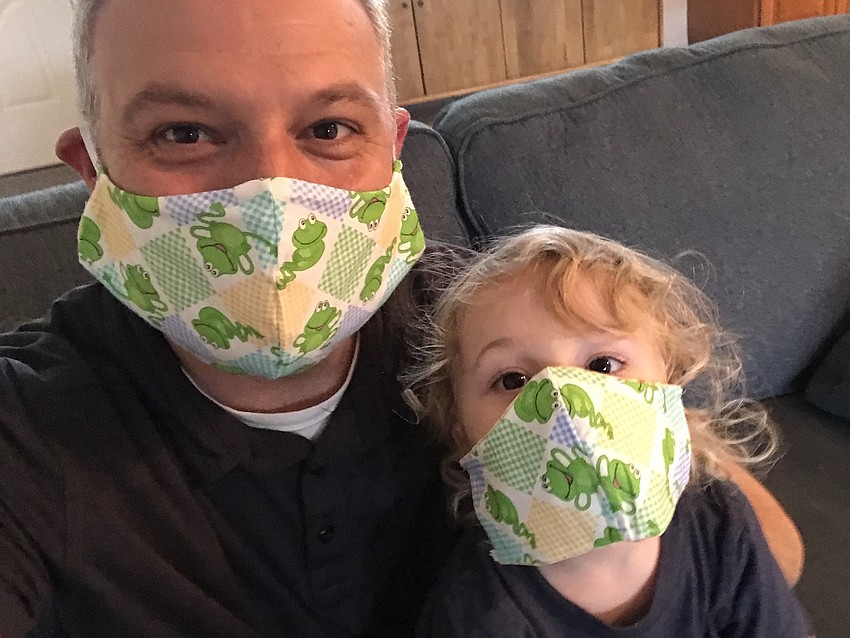 Temple Emanu-El Associate Rabbi Michael Shefrin and his son Jacob donned protective masks decorated with frogs – a reminder of the plague of frogs visited on Egypt during the Passover story.