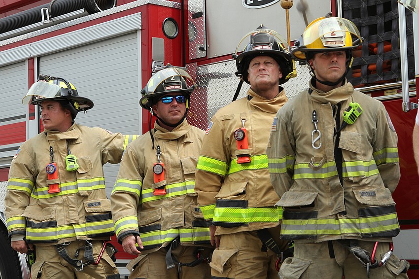 Sarasota County firefighters line up in front of their engine. Harry Sayer