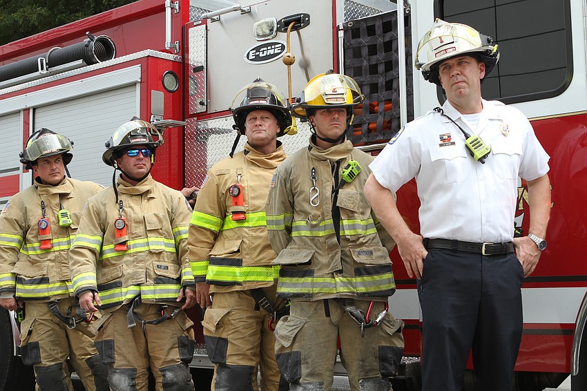 Sarasota County firefighters line up in front of their engine. Harry Sayer