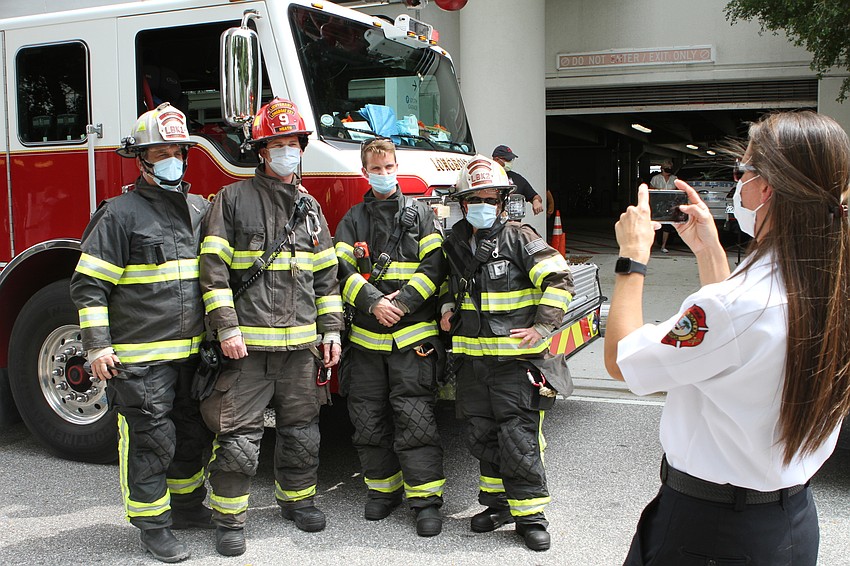 Longboat Fire EMS Liaison and PIO Tina Adams takes a photo of Longboat firefighters. Harry Sayer
