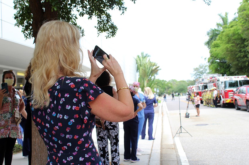 A hospital employee takes a video of the emergency personnel. Brynn Mechem