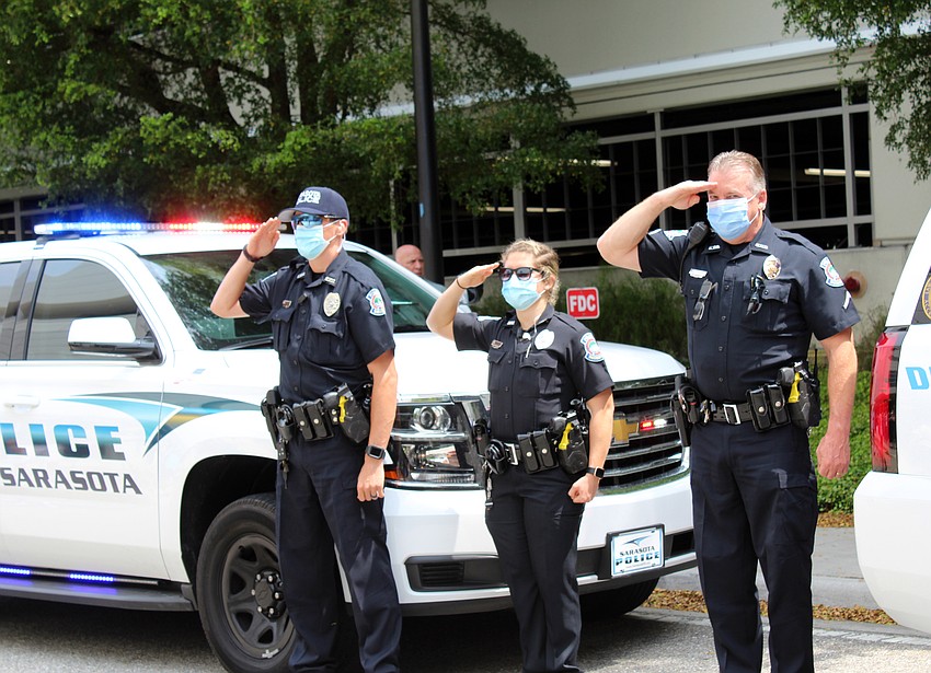 Sarasota Police officers salute the physicians. Brynn Mechem
