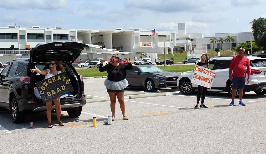 Hope Collingwood and Taylore Harris jump up and down as their students pass.