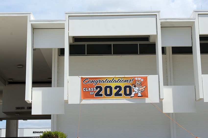 A banner hung on the school congratulates students for their work.