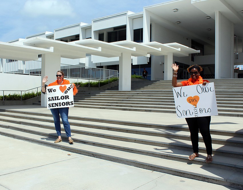 Assistant principals Michelle Anderson and Keatrun Stroughter cheer students on.