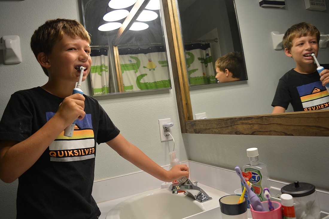 Lakewood Ranch 7-year-old Brayden Bishop  makes sure to turn  off the water while brushing his teeth.