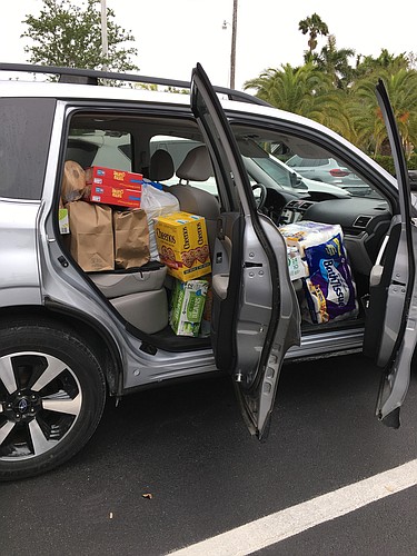 A car full of donations heads to Our Daily Bread of Bradenton.