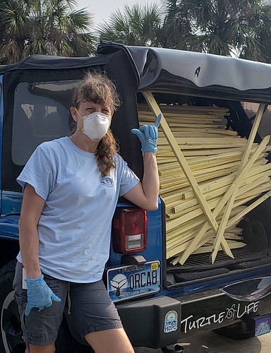 Charlene Donnelly helped transport the new batch of turtle nest stakes.