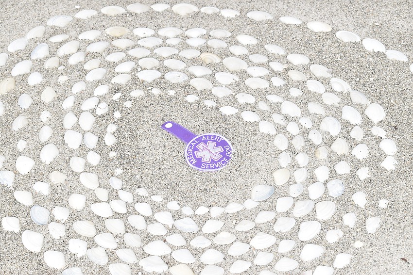 A service dog tag, another found object, centers another spiral.