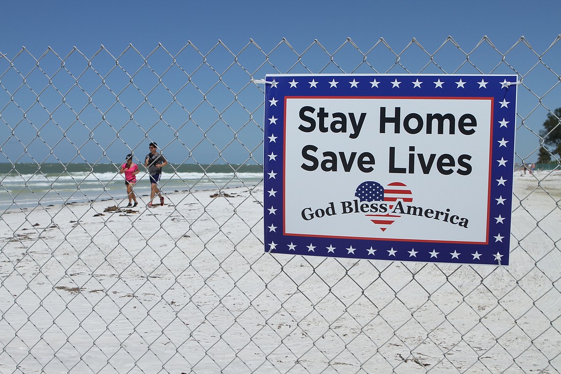 Sarasota residents returned to Siesta Key Beach on Monday after the county reopened the public properties. Lido Beach in the city of Sarasota remains closed. Photo by Harry Sayer.