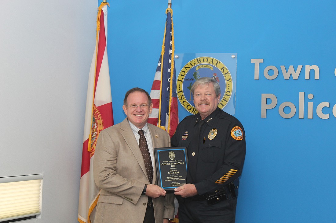 Police Chief Pete Cumming (right) presented Detective Eric Smith with the Officer of the Year Award.