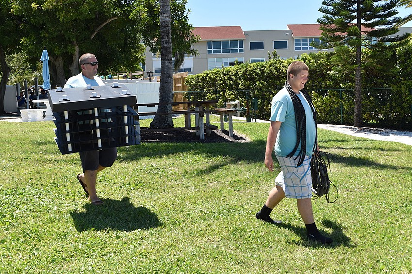 David Wolff (left) and his son, David Jr.,  carried Mini Reefs to one of the docks at the Longboat Harbor Condominium.