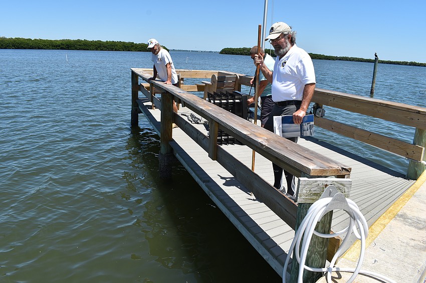 Longboat Harbor Condominium President Bill Coughlin overlooks the water.