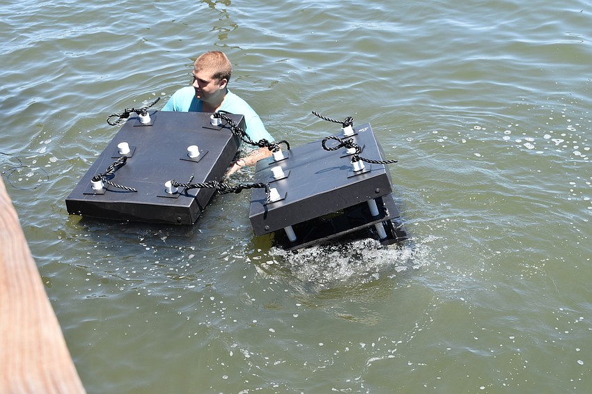 David Wolff Jr. installs two Mini Reefs underneath a dock at the Longboat Harbor Condominium.