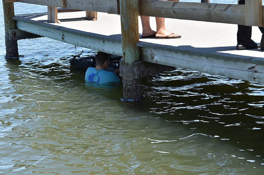 David Wolff Jr. installs two Mini Reefs underneath a dock at the Longboat Harbor Condominium.