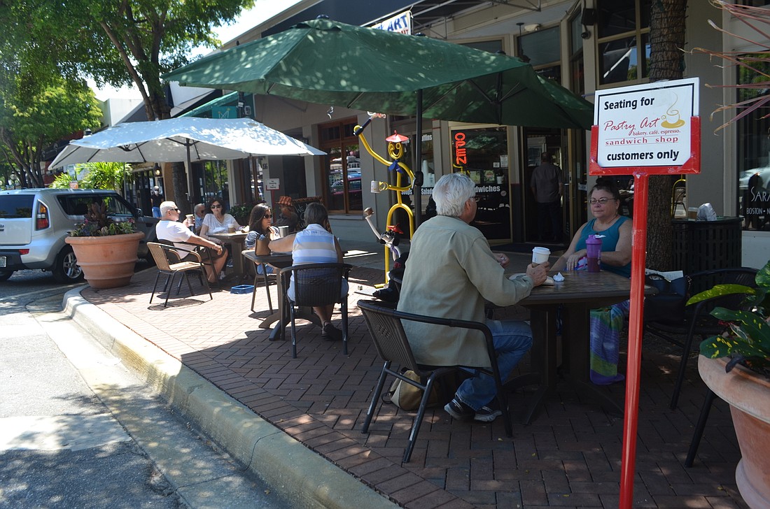 Customers sit outside Pastry Art Bakery Cafe on Monday afternoon, the first day outdoor dining was allowed following a statewide stay-at-home order associated with COVID-19.