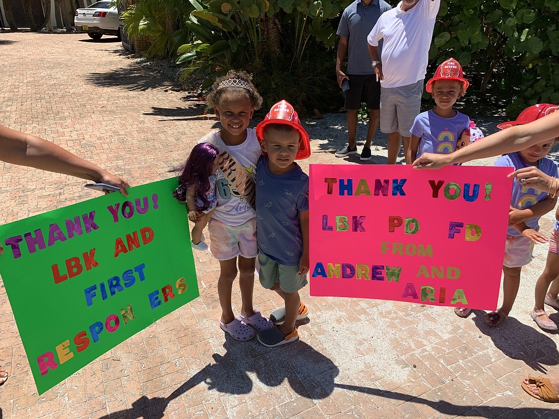 Aria and Andrew Mateos made signs for the parade.