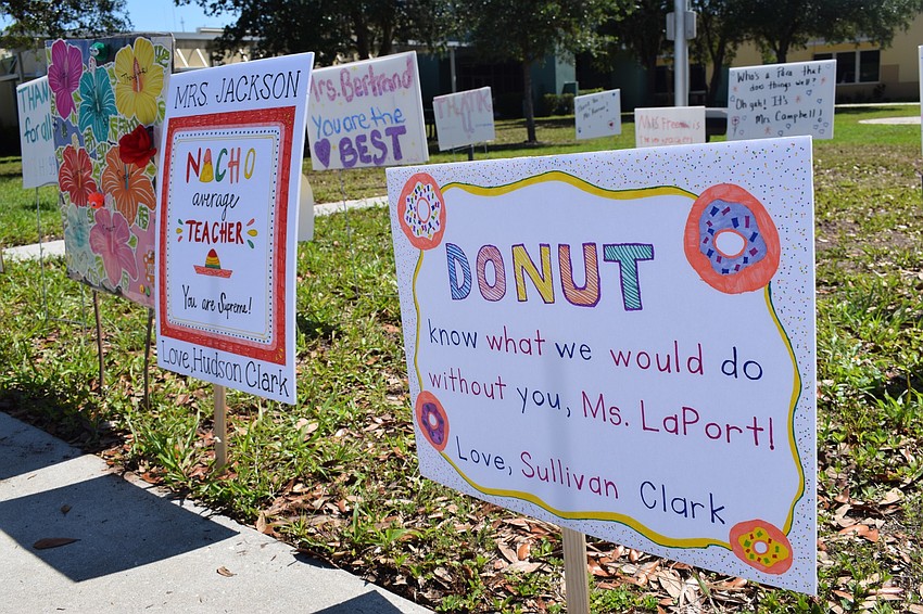 Dozens of families made signs for teachers and staff at Gilbert W. McNeal Elementary School.
