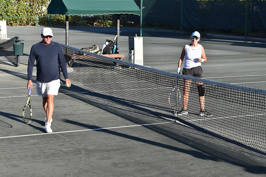 David Glorius and Kate Rhodes were the first two people to play when the Longboat Key Tennis Center reopened at 7:30 a.m. Friday.