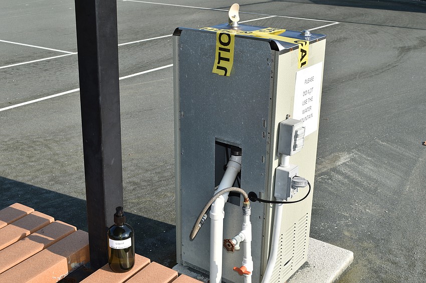 Each court at the Longboat Key Tennis Center has hand sanitizer and signs to prevent people from using the water fountains.