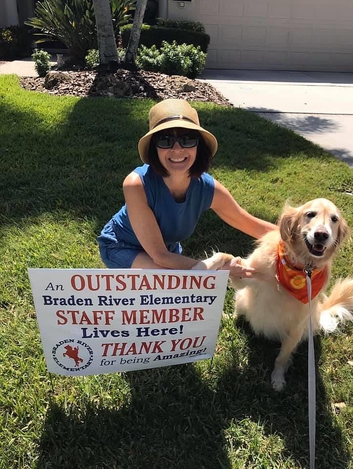 Teri Tiegland, an exceptional student education paraprofessional at Braden River Elementary School, loves the sign the school posted in her yard. The signs were a part of Teacher and Staff Appreciation Week.