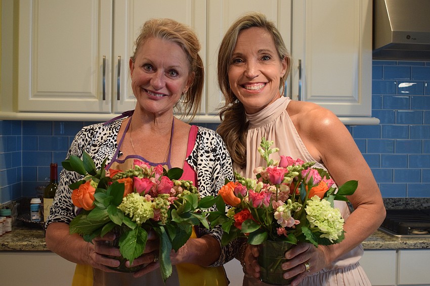 Robert E. Willis Elementary School fifth grade teachers Jacquie McLaurin and Suzanne Tomlin marvel over their finished arrangements.