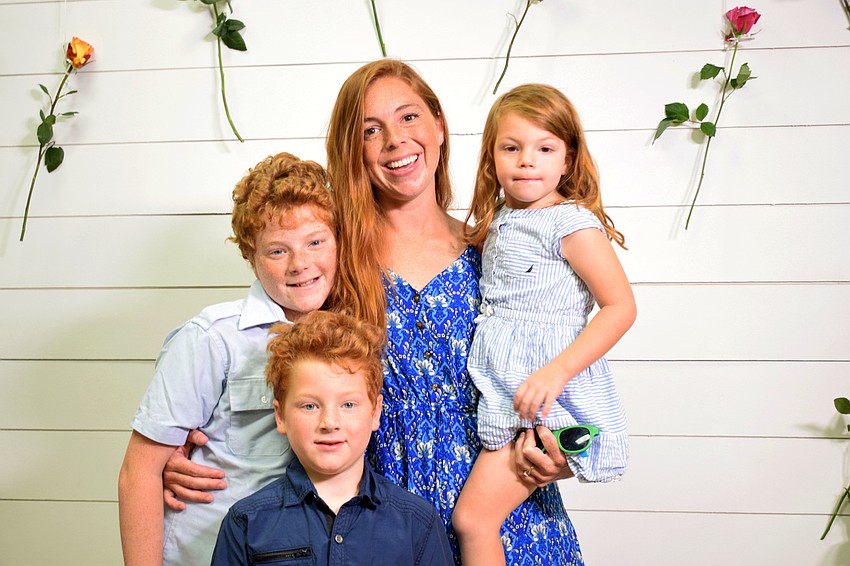 East County's Noah Laney, 12, smiles for a photo with his 6-year-old brother Asher, mother Bethany and 3-year-old sister Aribella.