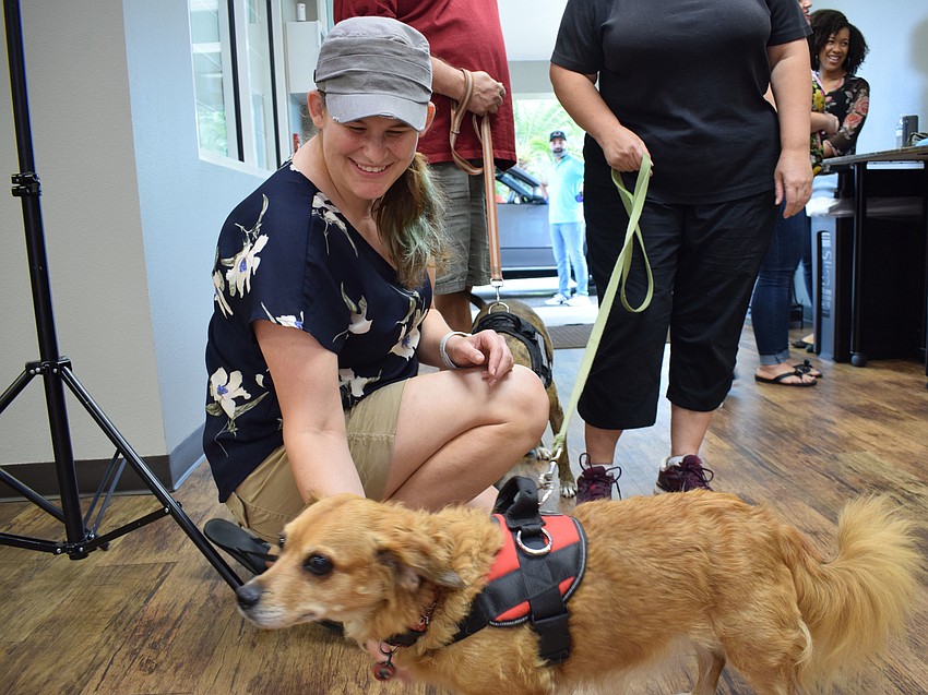 Hannah Kessie, a kids pastor for Oasis Church, pets Alyson Moyers' dog Gracy.