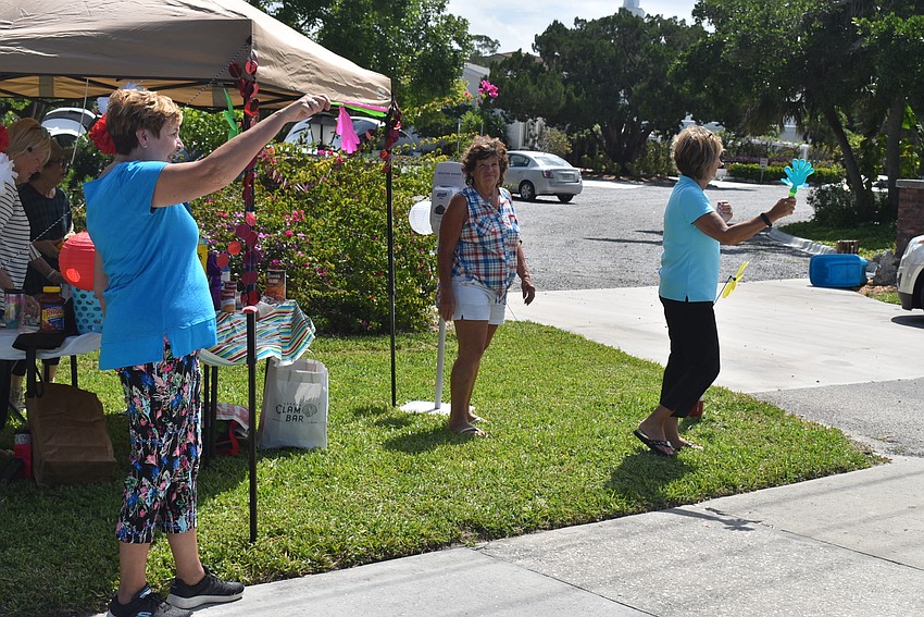 Volunteers wave at cars passing by.