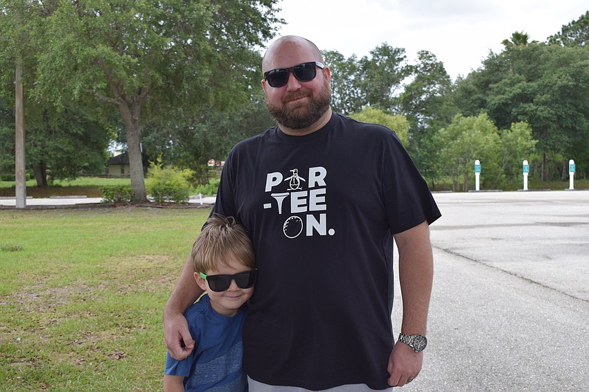 Judah Powell, who is 6 years old, gets ready to participate in the parade with his father, Cliff Powell.