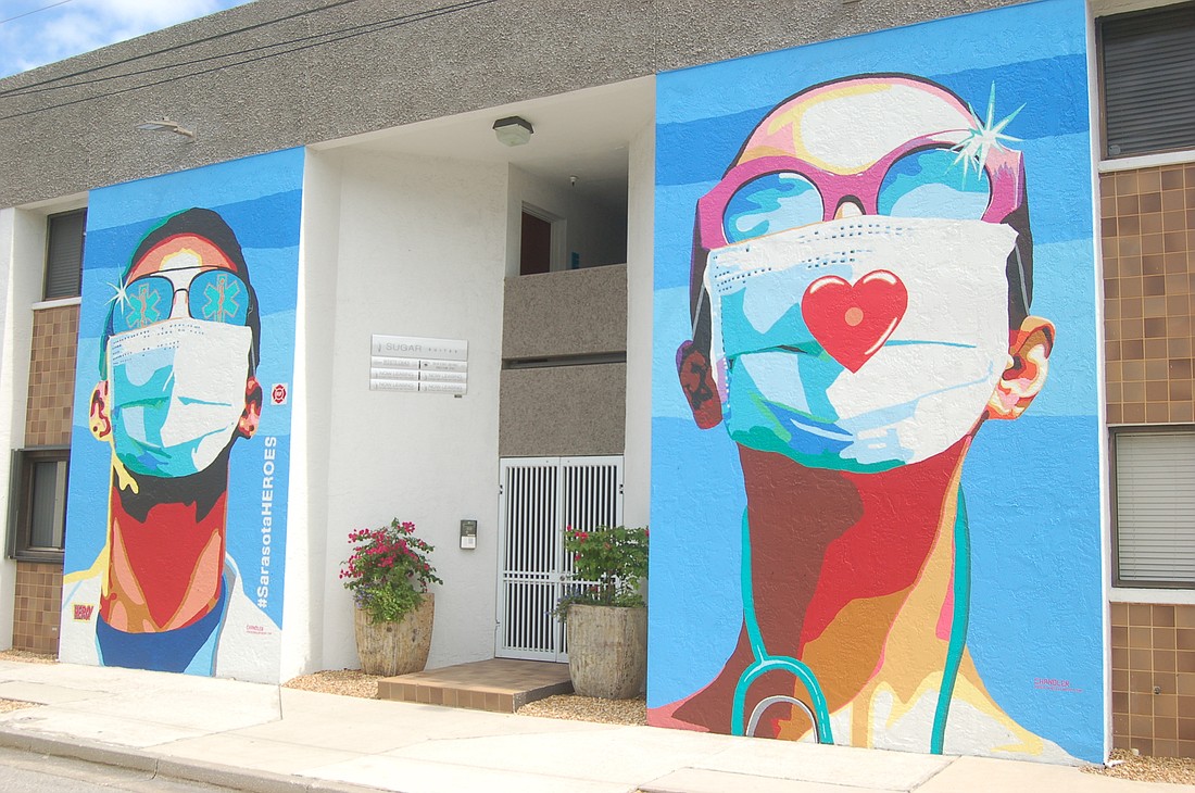 The twin murals, of a surgical masked man and a woman, were undertaken on April 28. An official unveiling took place May 15.