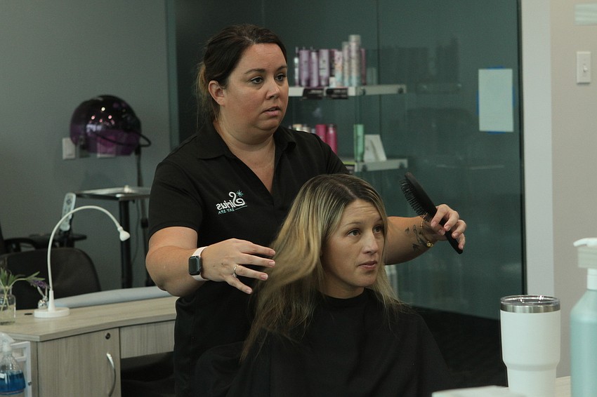 Sirius Day Spa manager Jenn Devine took her time touching up Lindsey Golonka 's hair.