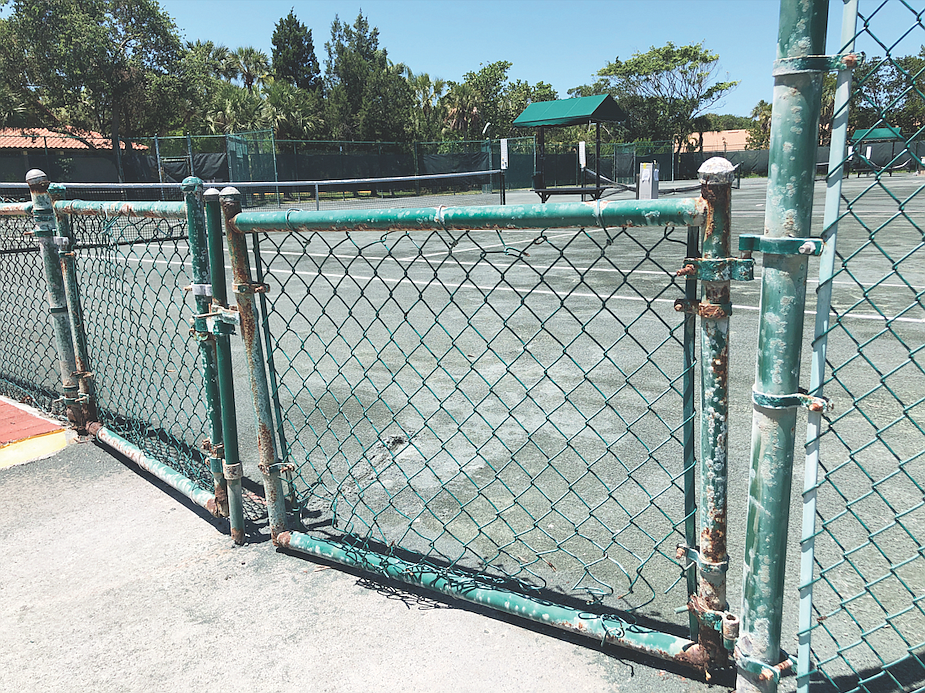 Fencing around the Longboat Key Public Tennis Center is showing the harsh effects of age and the humid air.