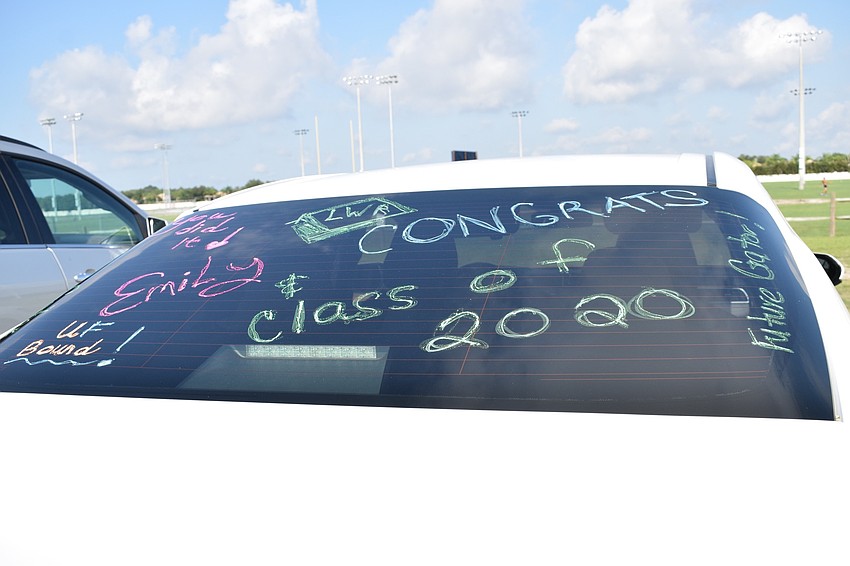 Fran Brandt decorates the back windshield of her car for her daughter Emily.