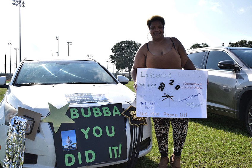 Trenisha Perry decorates her car and a sign for her son Omarius Miller.