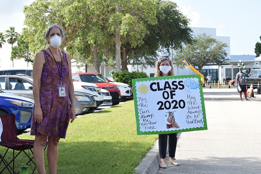 Deb Bailey and Catherine Franek love getting to see seniors as they drive by. Bailey says it's bittersweet.