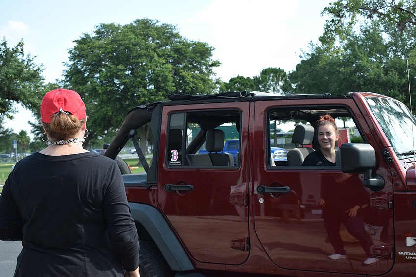 Macie Adams, a math teacher, talks to senior Brooke Roberts. Roberts says it was fun to see her teachers again after being out of school for months.